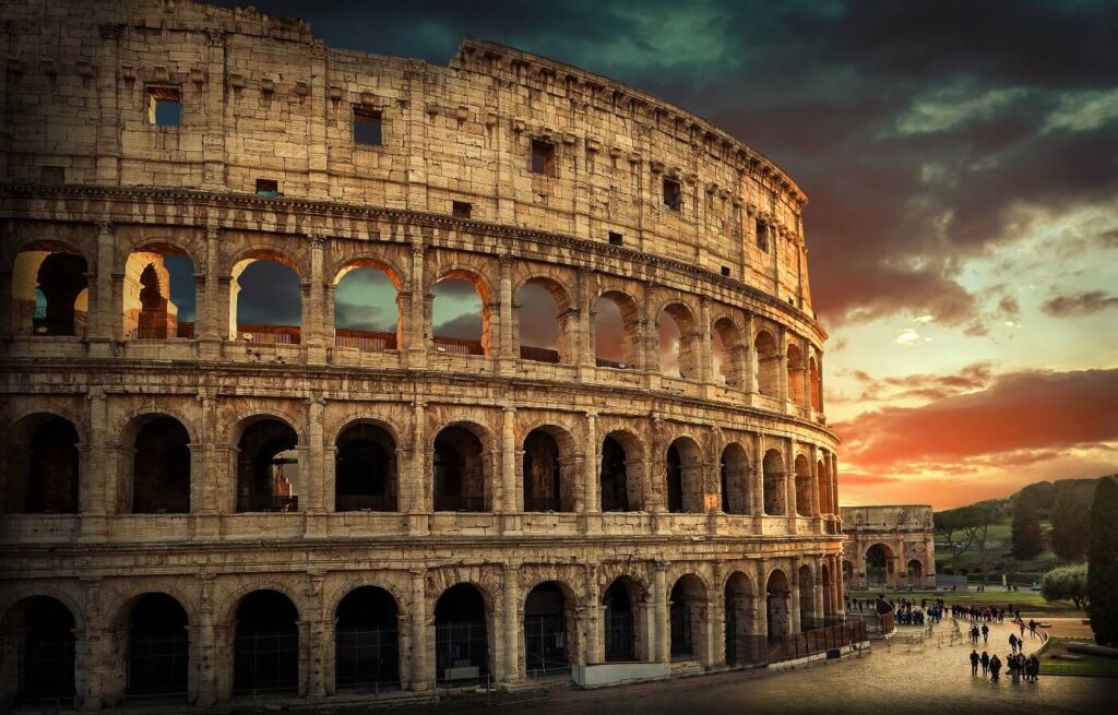 One of the most popular travel place in world - Roman Coliseum under evening sun light and sunrise sky.